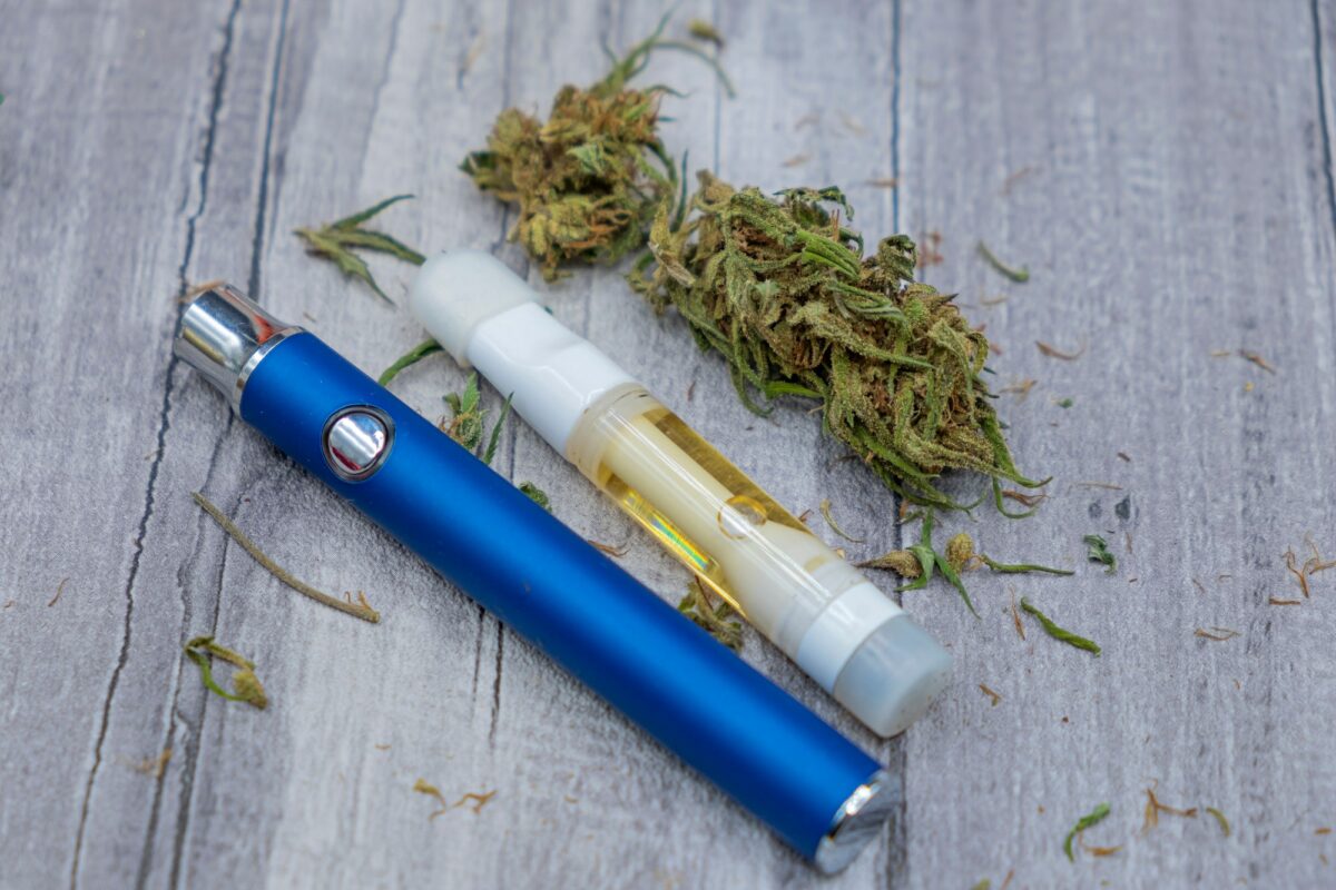 CDB. Cannabis oil extract In Vape pen cartridge and marijuana buds. Medicinal weed
