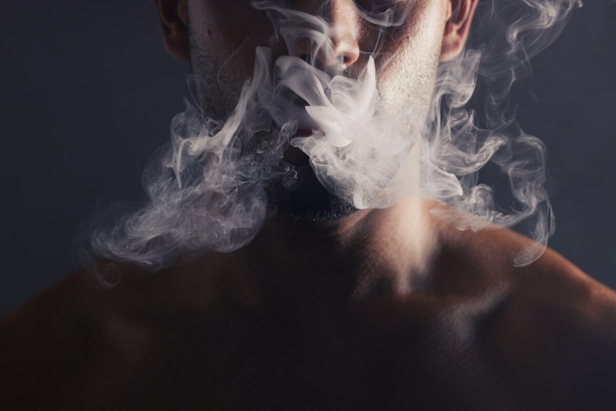 Smoke, cloud and face of man with pollution for marijuana smoker health campaign with zoom. Cannabi