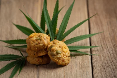 Dos and Don'ts of Consuming Edibles - cannabis cookies and cannabis leaves put on wooden floor