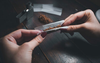 The Benefits of Pre-Rolls - High-angle shot of a female rolling a joint